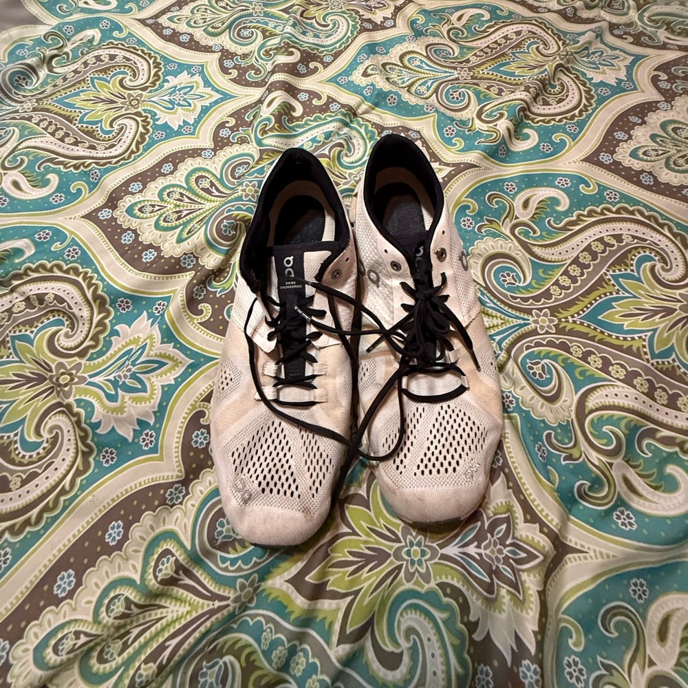 On Running Cream and Black Sneakers